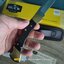 มีดพับ Buck110 Folding Hunter 3.75" Plain Blade, Finger Grooved, Ebony Wood Handles, Leather Sheath - 2538